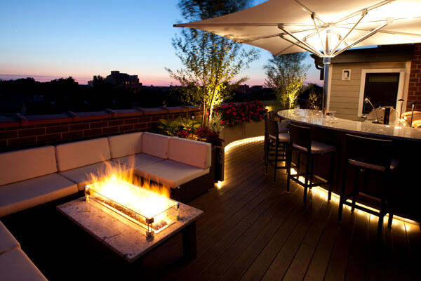 propane fire pit on deck next to bar