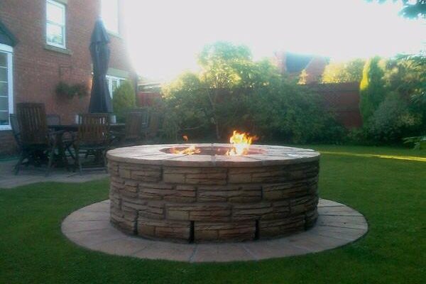 outdoor stone fire pit in lawn