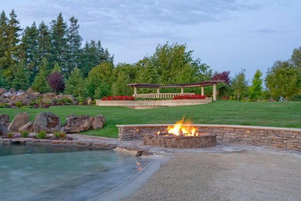 outdoor propane fire pit next to pool